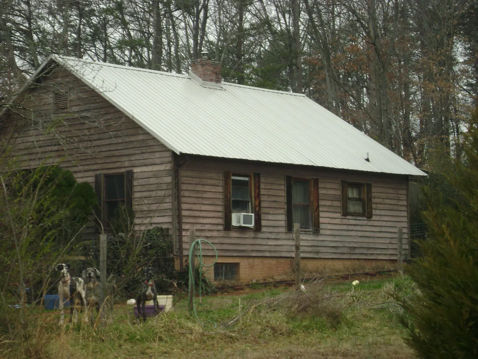 White metal roof on an old wood sided farmhouse, from a Metal Roof Installation job in Cullen